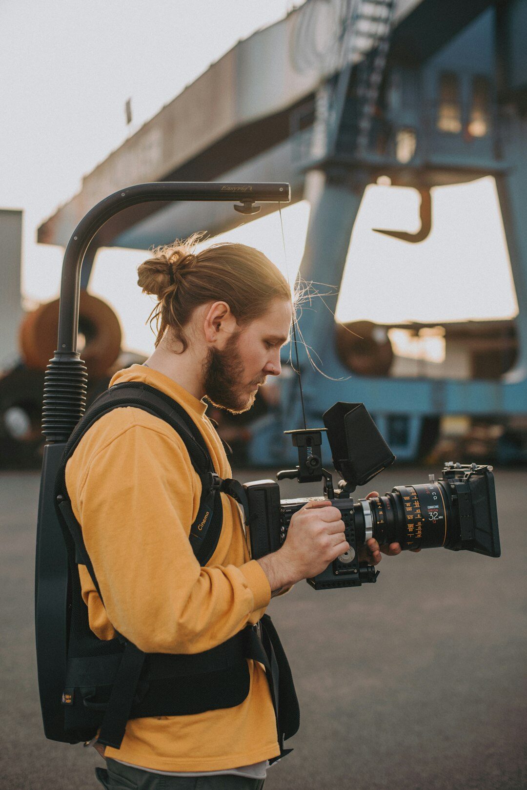 Finnish male camera operator holding a professional broadcast camera on his shoulder